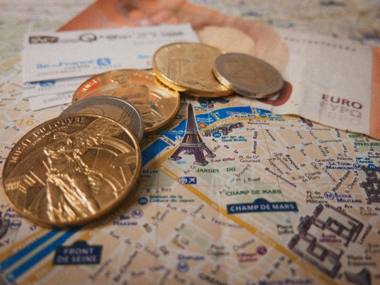 a bunch of coins sitting on top of a map